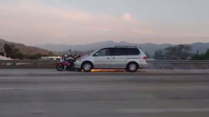 Driver accused of speeding away from hit-and-run with motorcycle on front bumper